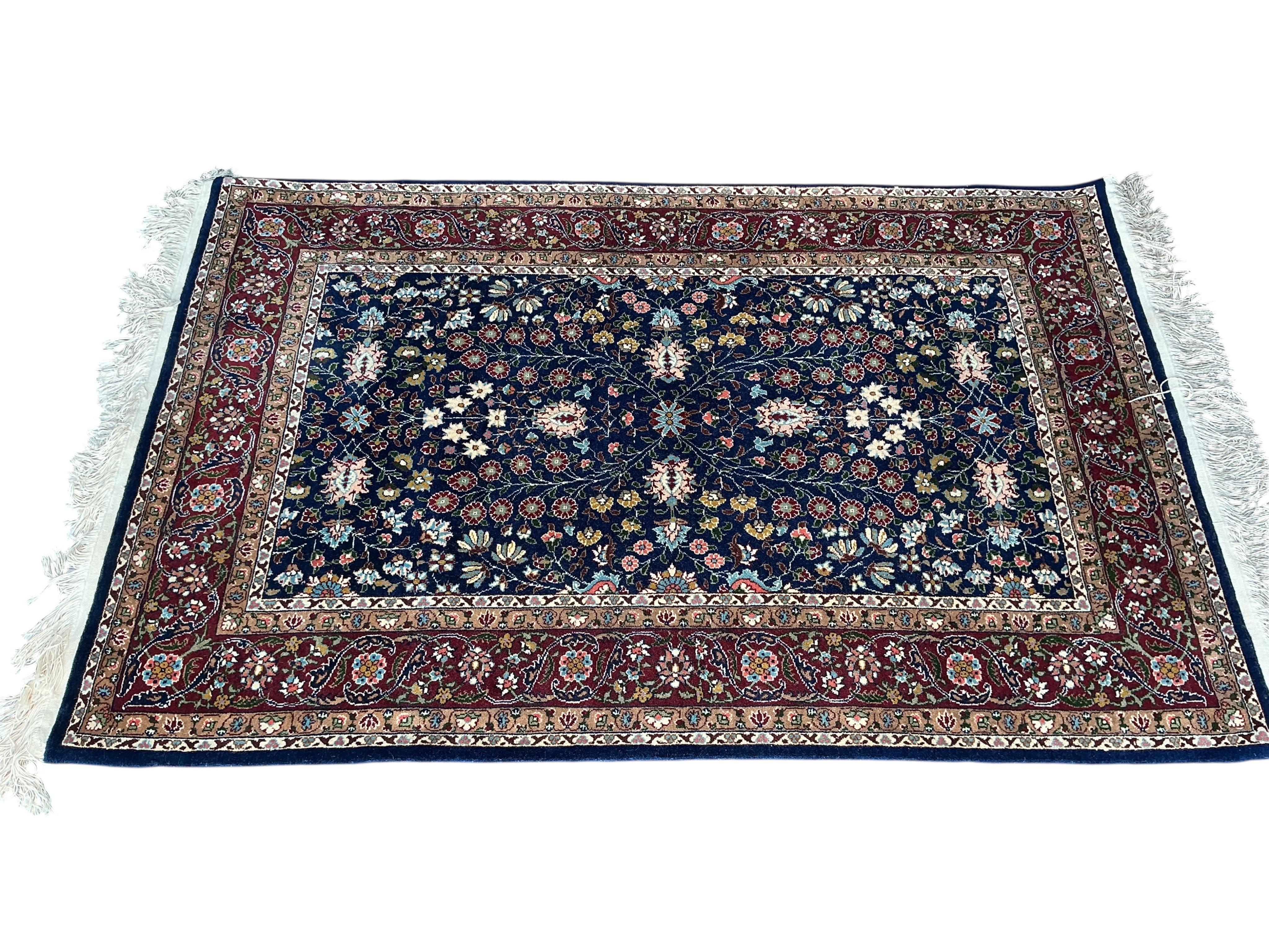 A Hereke Turkish blue ground rug, 150 x 100cm